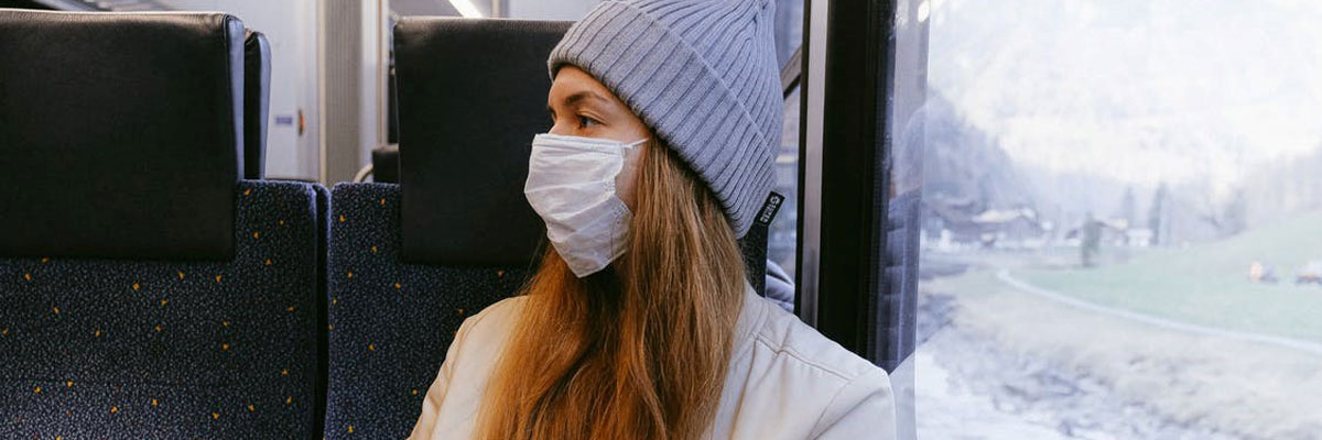 Girl on train with mask on